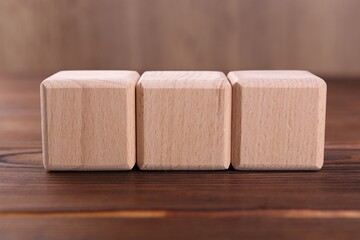 Cubes with abbreviation ISO on wooden table, closeup