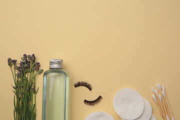 Flat lay composition with makeup remover and lavender on yellow background. Space for text