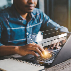 User use a laptop computer to download and update software with waiting to load digital file data from the website, and very slow internet from wifi. Concept of waiting for a load of loading symbol