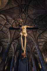 Painted wooden sculpture of Jesus Christ being crucified