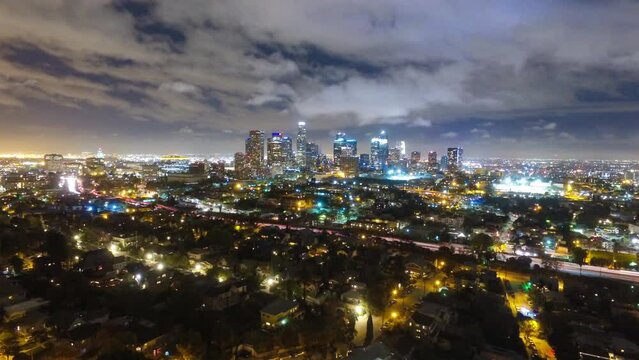 Aerial Time Lapse Shot Of Vehicles Moving In Illuminated City Against Sky At Night - Los Angeles, California