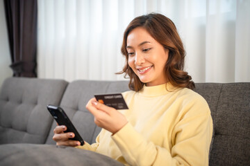 Women using Smart phone and Laptop for shopping online and payment with Credit card at home