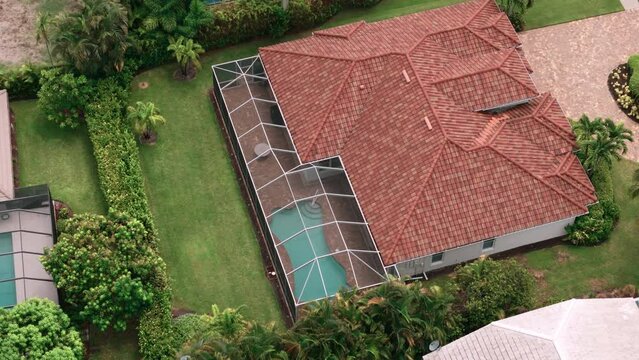 Aerial Above wide view of screened in pool in florida house. Top down move shot