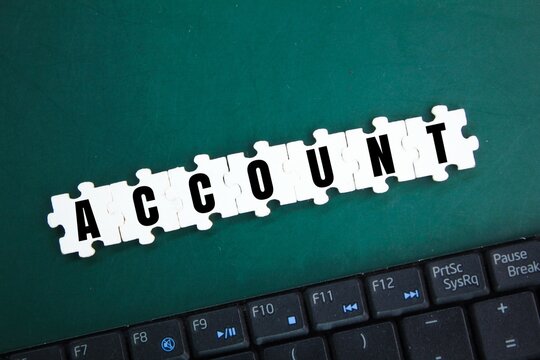laptop keyboard and puzzle with the word Account. the concept of opening an account or saving