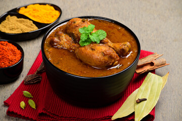 Indian style spicy chicken curry in bowl