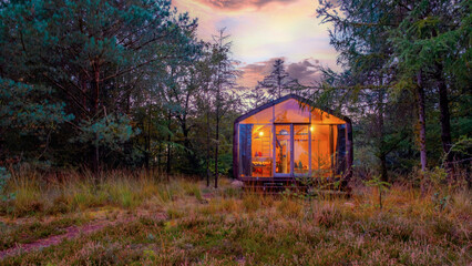 Wooden hut in autumn forest in the Netherlands, cabin off grid ,