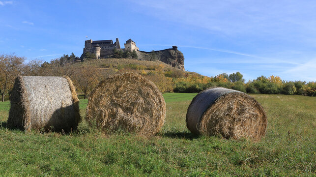 Medieval Boldogkő castle in Borsod-Abaúj-Zemplén county, Hungary, with straw bales in the foreground.