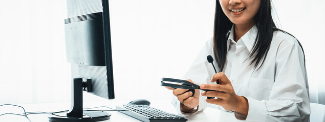 Business people wearing headset working in office to support remote customer or colleague. Call...