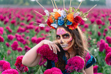 Mexican Woman in Mexico, Catrinas makeup in flower field, wearing traditional costum, crown of...