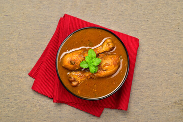 Top view of indian style spicy chicken curry in bowl