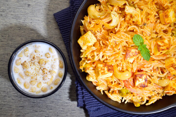 Top view of paneer pulao with boondi raita