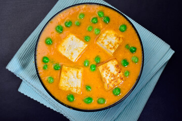 Matar paneer in bowl top view, famous indian dish peas and cottage cheese curry