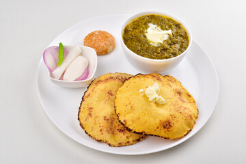Saag roti with jaggery in plate on white background