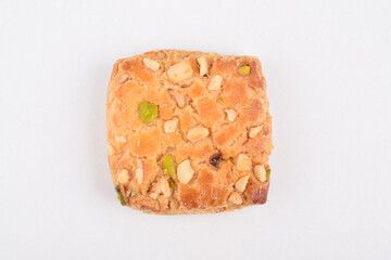 Top view of baked pistachio biscuits on white background