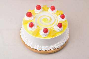 Yellow cake with cherry on white background