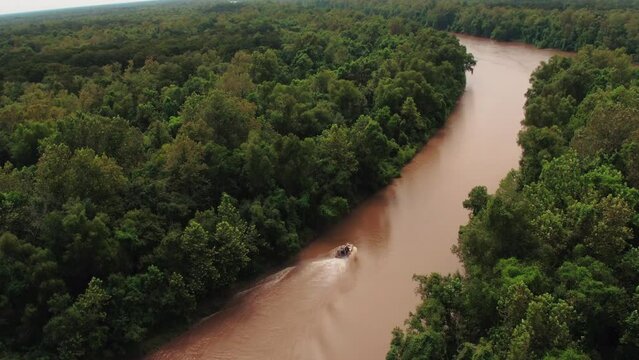 Aerial Panning Shot Of Airboat Splashing Wake On River Amidst Trees Against Sky - Bayou, Louisiana