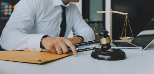 Judge gavel with Justice lawyers having team meeting at law firm in background. Concepts of law.