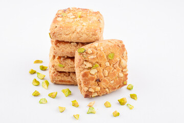 Baked biscuit isolated on white background with chopped pistachio