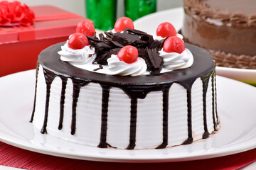 Chocolate and vanilla cake with red cherry