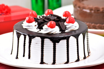 Closeup of chocolate vanilla with cherry, whole cake