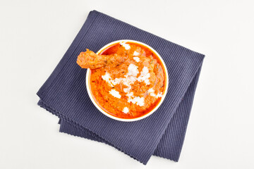 Top view of butter chicken on white background, punjabi food