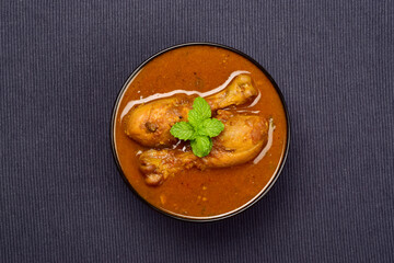 Top view of masala chicken curry in bowl