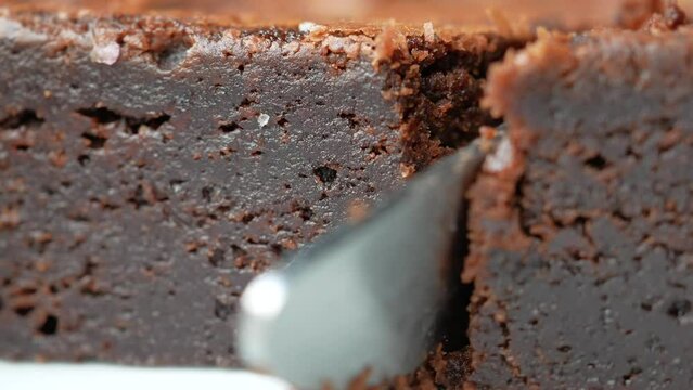 cutting a slice of brownie with a knife 
