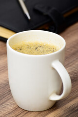 Cup of black coffee at table