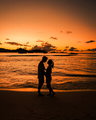 Fototapeta premium Anse Patates, La Digue Seychelles, young couple men and woman on a tropical beach during a luxury vacation in the Seychelles. Tropical beach Anse Patates, La Digue Seychelles