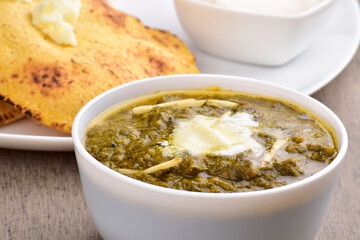 Sarso ka saag bowl on table, healthy punjabi food
