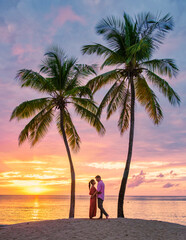 couple on beach with palm trees sunset at the tropical beach of Saint Lucia or St Lucia Caribbean