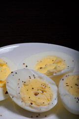 Boiled eggs with seasoned black pepper in plate