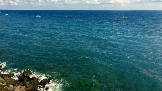 Ambient motion gentle waves and bobbing traditional basnigan fishing boats or outrigger boat in the coastal town of Basay Negros Oriental Philippines