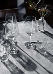 Wineglasses cast shadows in the afternoon sun.