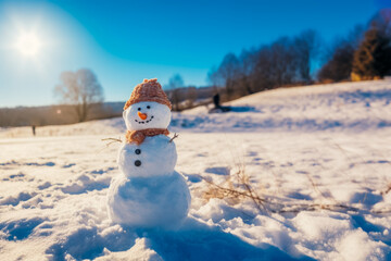 Fototapeta premium snowman on the snow in an open field