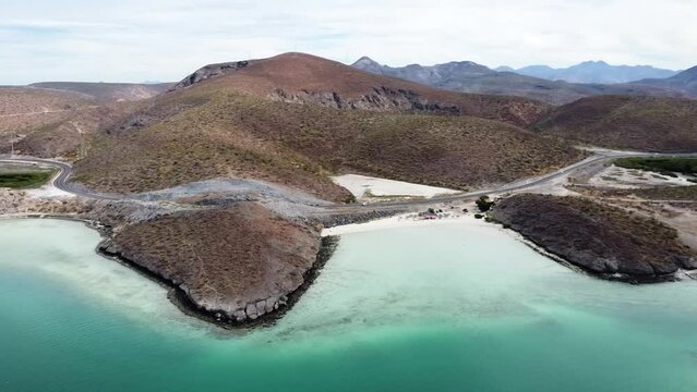 Aerial view over the gorgeous coastline overlooking the pristine beach and turquoise sea in Playa El Tecolote Baja California Sur Mexico during a great trip