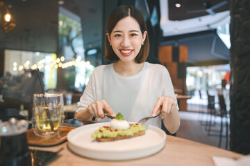 Asian woman eating healthy food at cafe restaurant city break on weekend lifestyle