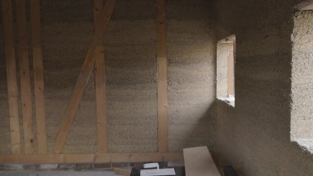 Inside view of a hempcrete wall in wooden frame with windows unter construction