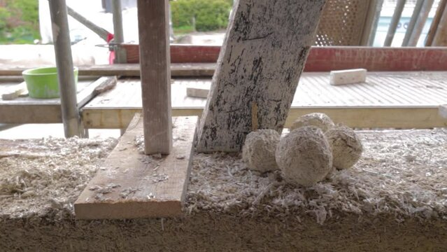 Detail view of test sample balls of hempcrete in a construction site