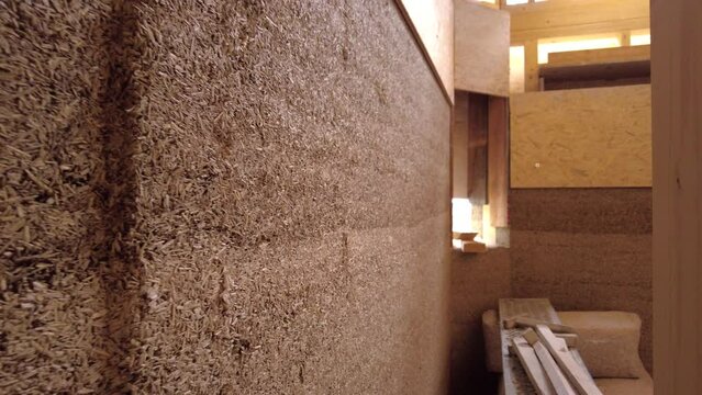 Close-up of hempcrete wall from the side passing by