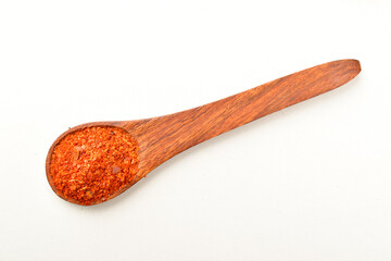 Top view of red chilli powder in spoon isolated on white background