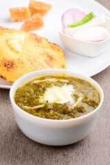 Sarso ka saag in bowl with corn chapati, punjabi food
