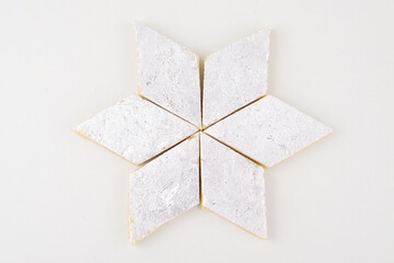 Top view of kaju katli on white background, indian sweet