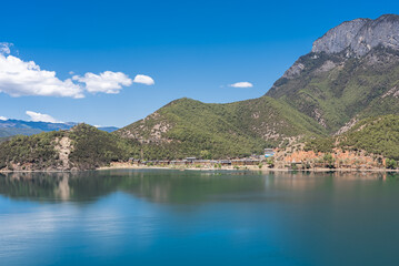 Fototapeta na wymiar The reflection of blue sky and white clouds on the water surface of Lugu Lake in China