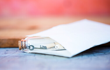 Fototapeta premium Love key and scroll in glass message bottle, valentine background, love and romance concept