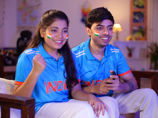 Siblings wearing an Indian jersey - excited  cheering for a team  female sports fan  cricket...