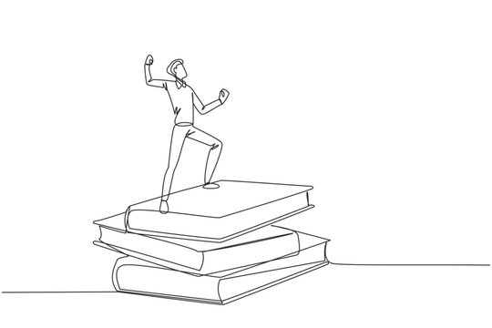 Single continuous line drawing of young businessman standing on stacks of giant books fist hands up. Reading improves his skills in business world to become a successful entrepreneur. One line design