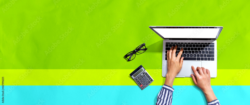 Poster person using a laptop computer from above