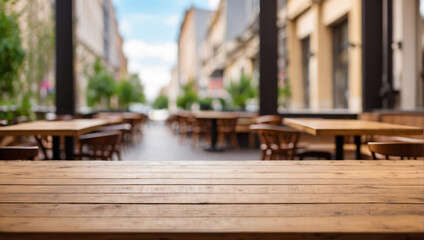 Fototapeta premium empty wooden desk cafe with blurred background of city street