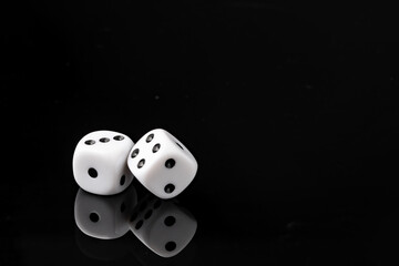 White dice on black background studio shot